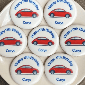 A plate with seven cookies on it that say " happy 1 7 th birthday carys ".